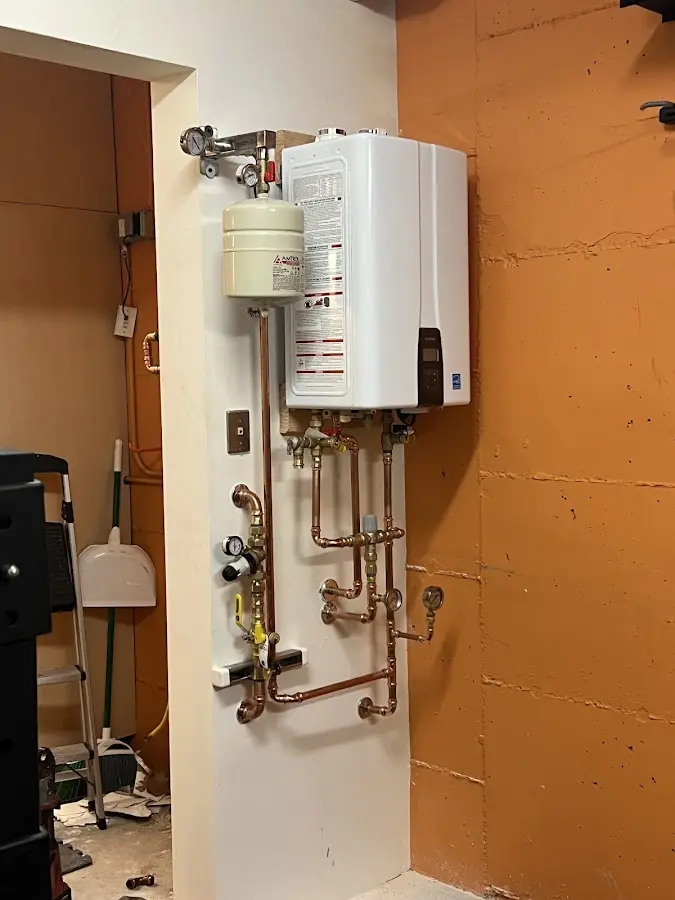 Plumbing technician inspecting water heater connections in South Heidelberg